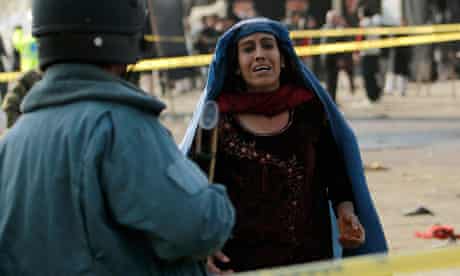 Afghan woman mourns after a suicide attack
