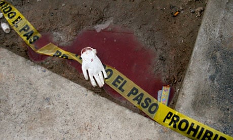 Tape used to cordon off a crime scene lies surrounded by blood in Ciudad Juarez