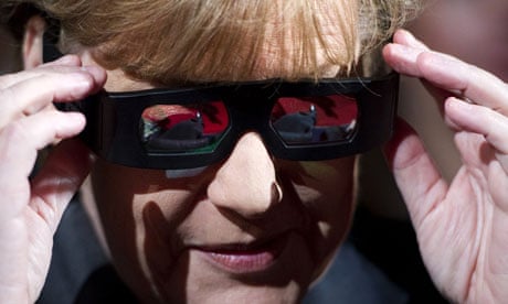German Chancellor Angela Merkel adjusts her 3D glasses at Pina