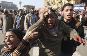 Egypt clashes day 9: A wounded demonstrator is evacuated from Cairo's main square
