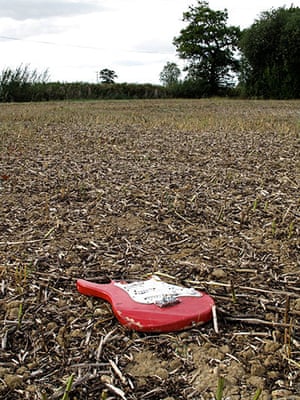in pictures: broken: broken guitar in field