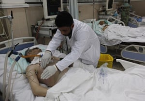 libya: A Libyan doctor treats a wonded man