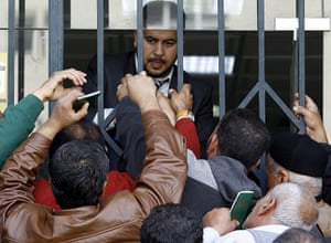 Libya: People collect their cash handouts from the government at a bank in Tripoli