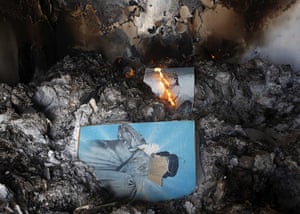 Benghazi celebrates: Burnt pictures of Gaddafi