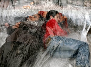 Egypt day 14: Demonstrators sleep under a plastic sheet in Cairo