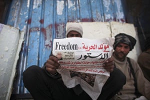 Egypt day 14: An anti-government protester reads a newspaper near Tahrir Square