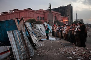Egypt day 14: Egyptian anti-government demonstrators pray at a barricade 