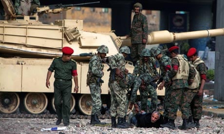 A pro-Mubarak supporter is carried away by Egyptian soldiers 
