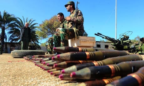 Libyan soldiers who have defected against Moammar Gaddafi guard anti-aircraft guns