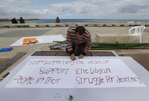Benghazi Protests: An anti-Libyan leader Moammar Gadhafi protester, prepares banners