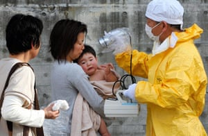 Japan tsunami rescue: Medical personnel check a mother and son for radiation exposure in Kawamata