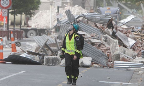 A New Zealand urban search and rescue worker walks through central business district of Christchurch