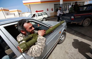 Eastern Libya: Rebel fighter with rocket launcher at gas station in Alaguila