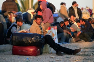 Refugees Flee Libya: An Egyptian who fled Libya a few days ago, sits on his luggage