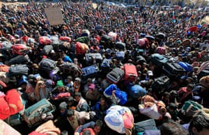 Refugees Flee Libya: Bangladeshi migrant workers wait near the Tunisian gate of border crossing