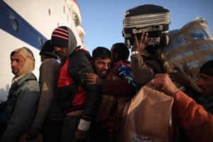 Refugees Flee Libya: Indian workers attempt to get on a ship leaving for Alexandria, Egypt