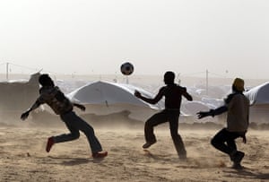 migrant workers flee : Refugees from Libya play football 