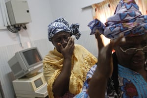 Ivory Coast violence: Women react at a health clinic where a dozen injured people were taken