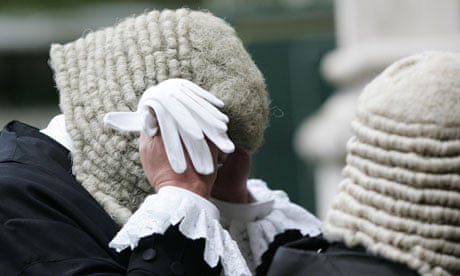 A judge adjusts his wig
