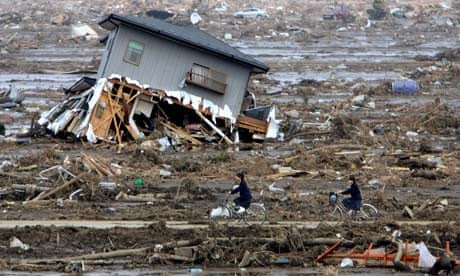 Junior high school students return home through the rubble in Yamamoto, Miyagi, Japan