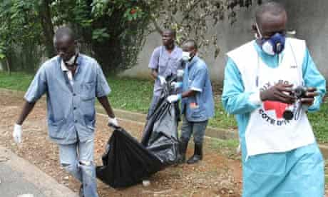 Red cross members remove a body in Abidjan