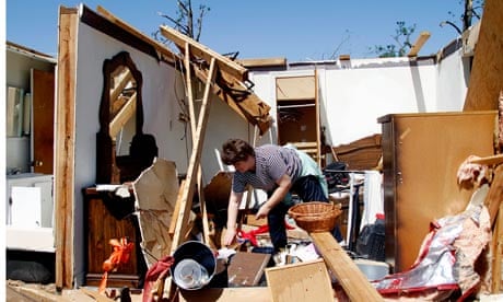 North Carolina resident Deborah Dulow cleans up after the tornadoes