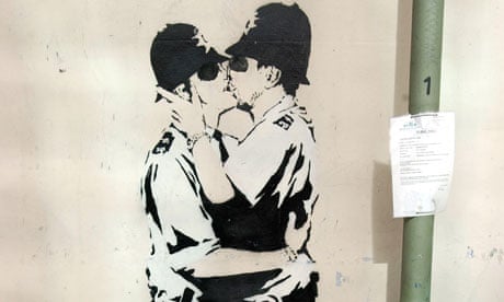 Kissing cops graffiti by Banksy