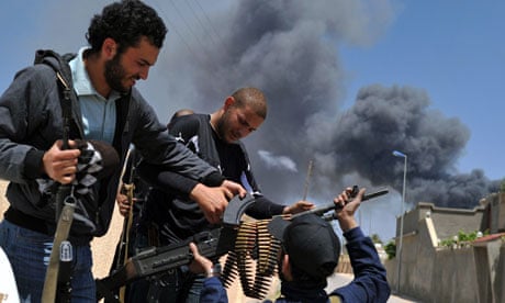 Libyan rebel fighters unload weapons in Misrata