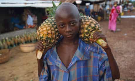 Sierra Leonian Boy Carrying Pineapples