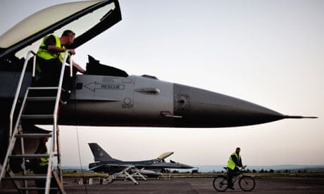 A Danish F-16 strike aircraft is reviewed after a mission over Libya in the Nato campaign