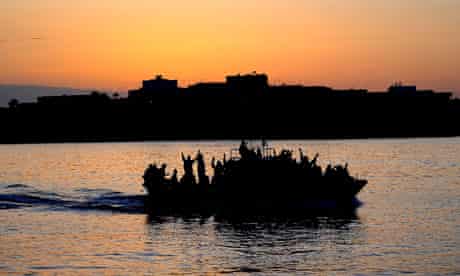 A boat carring Tunisian migrants enters Lampedusa