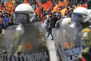 Protests in Athens: Riot police look on as demonstrators march in front of Greek parliament 