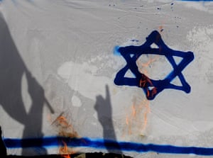 Israel violence: Protesters set fire to an Israeli flag in Istanbul