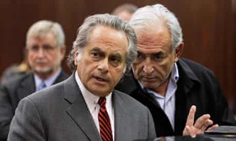 Strauss-Kahn consults with his lawyer Benjamin Brafman as he appears in Manhattan Criminal Court