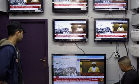 Palestinians watch the news about Osama bin Laden's death