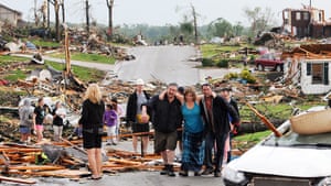 US tornado: Residents in Joplin help a woman after a tornado hit