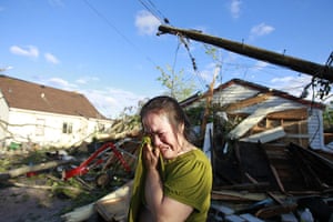 US tornado: Chue Vang reacts beside her home that was damaged in a tornado, Minneapolis