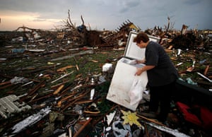 US tornado update: Anita Stokes salvages meat from a freezer at her home in Joplin