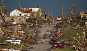 US tornado update: A man salvages a guitar from a severely damaged home in Joplin