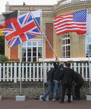 G8 summit:  Workers raise a British flag after noticing it had been upside down