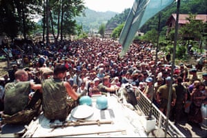 Ratko Mladic: Dutch UN peacekeepers sit while Muslim refugees from Srebrenica gather