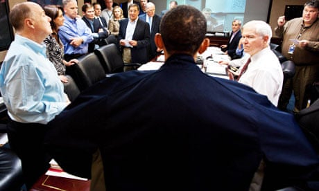 Barack Obama looms at the head of the table in this photograph from the White House situation room