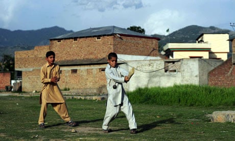Boys play cricket near Osama bin Laden's last hideout in Abbottabad, Pakistan
