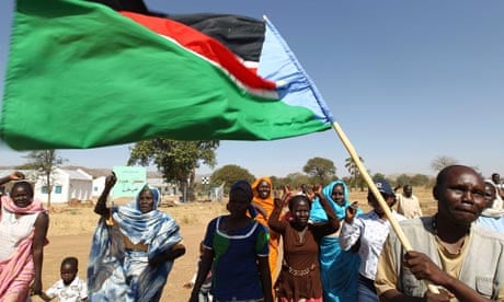 A Sudanese man waves the regional flag