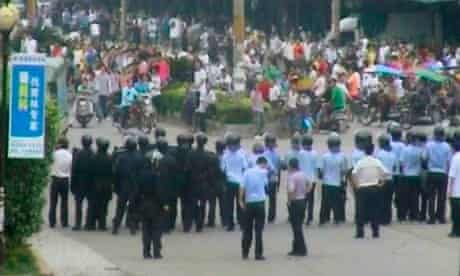 Riot police block a road in Zengcheng, China