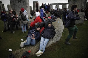 Summer solstice: Revellers rest on a stone 