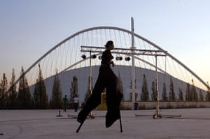 Greece: Spring 2006: Bouncing back? A stilt performer passes the Olympic Velodrome