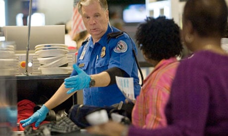 Passengers at Dallas/Fort Worth airport have their belongings x-rayed by a TSA officer