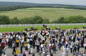 Glorious Goodwood : Runners in the Maiden Fillies' Stakes go past the Grandstands