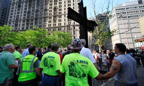 World Trade Centre construction workers hold hands during a prayer at a ceremony for the 9/11 cross